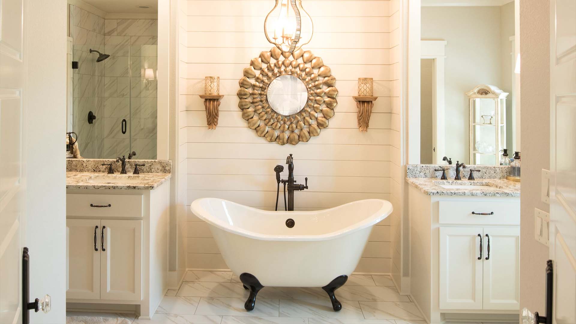 A beautiful bathroom with white and gold accents